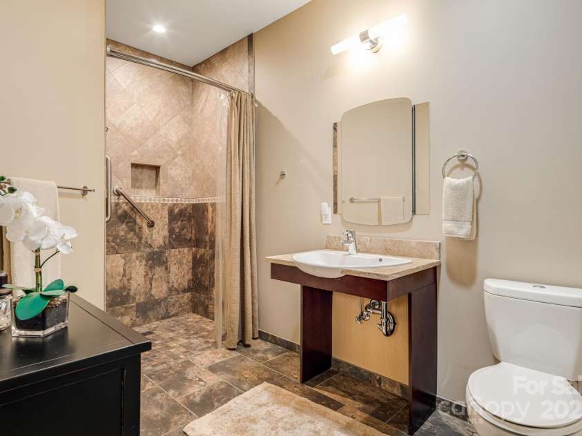 1760 Winding Creek Drive, Waynesville, NC 28786.  MLS# CAR4264715, YatesRealty ID 16223. Ensuite primary bathroom, wheelchair accessible sink and shower