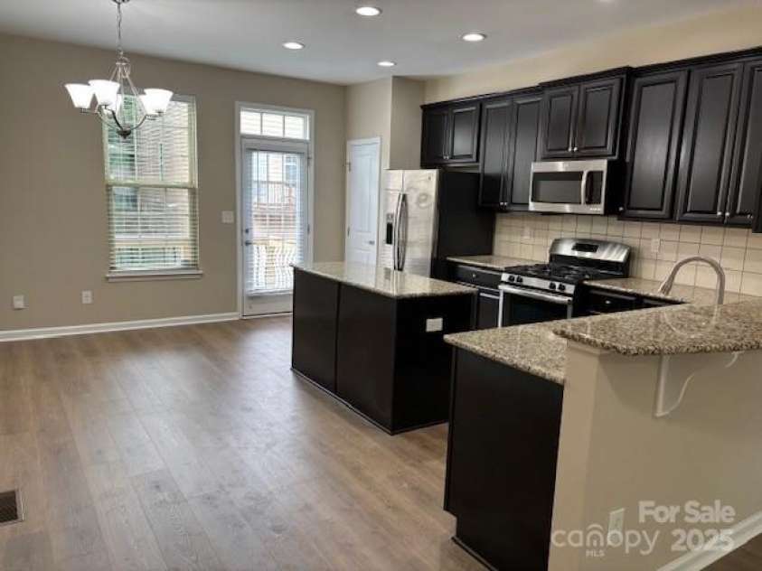 13838 Winmau Lane, Huntersville, NC 28078.  MLS# CAR4256068, YatesRealty ID 16237. Open Kitchen, granite tops, stainless appliance, gas range, new LVT/plank floors, pantry and walk out balcony