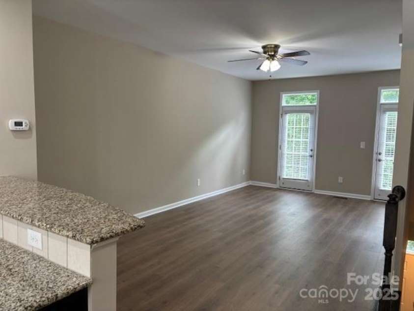 13838 Winmau Lane, Huntersville, NC 28078.  MLS# CAR4256068, YatesRealty ID 16237. Open view of the living space from the kitchen - natural lighting permeates the space.