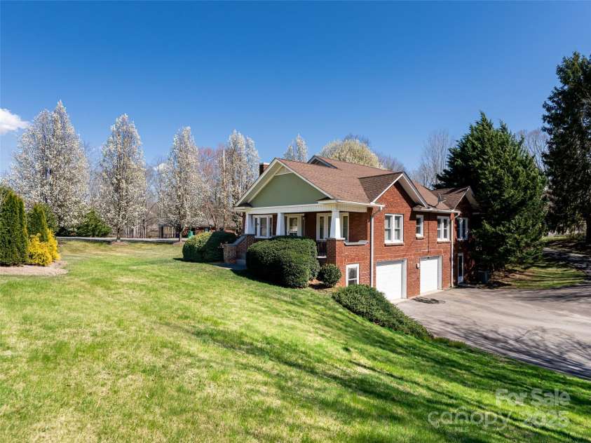 1305 Pisgah Highway, Candler, NC 28715.  MLS# CAR4245961, YatesRealty ID 16242. Beautiful tree lined lot.