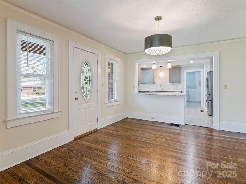 1305 Pisgah Highway, Candler, NC 28715.  MLS# CAR4245961, YatesRealty ID 16242. Large dining room with lots of natural light and access to side porch