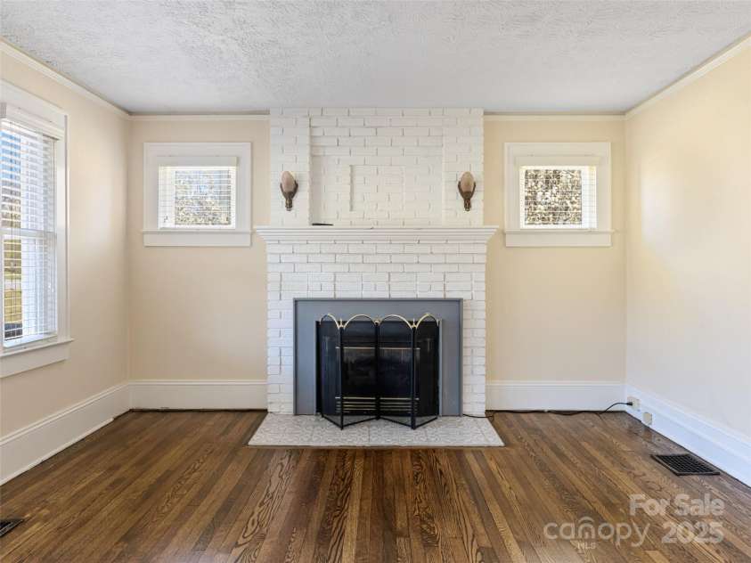 1305 Pisgah Highway, Candler, NC 28715.  MLS# CAR4245961, YatesRealty ID 16242. Original fireplace with propane gas log insert.