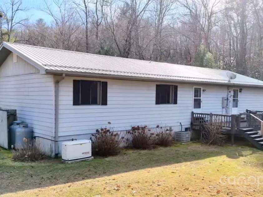 262 Rooster Cove, Brevard, NC 28712.  MLS# CAR4332799, YatesRealty ID 1626. Back side of house showing whole home generator