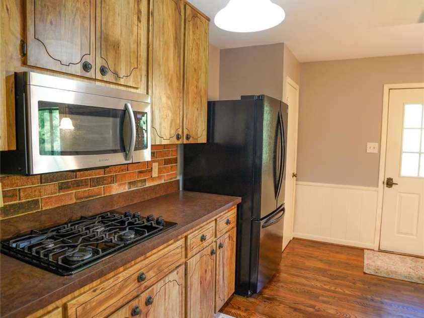 262 Rooster Cove, Brevard, NC 28712.  MLS# CAR4332799, YatesRealty ID 1626. Kitchen has access to back deck