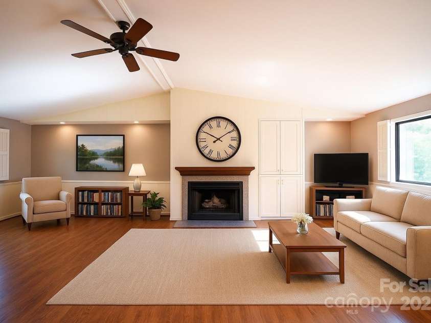 262 Rooster Cove, Brevard, NC 28712.  MLS# CAR4332799, YatesRealty ID 1626. Large, bright, open living area with vaulted ceilings and gas logs. Virtually staged.