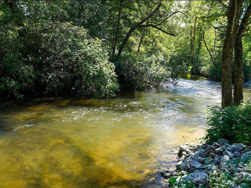 262 Rooster Cove, Brevard, NC 28712.  MLS# CAR4332799, YatesRealty ID 1626. The French Broad River, just across the road from the driveway