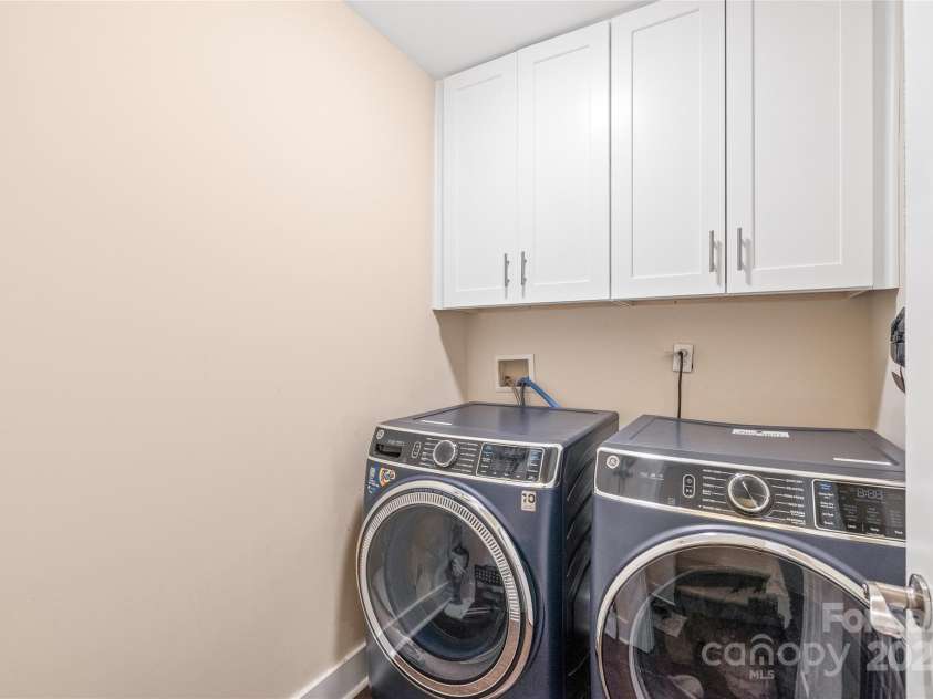 219 Lee Street, Fort Mill, SC 29715.  MLS# CAR4257682, YatesRealty ID 16267. Convenient walk-in laundry room with added upper cabinets—just steps from the primary bedroom for easy living.