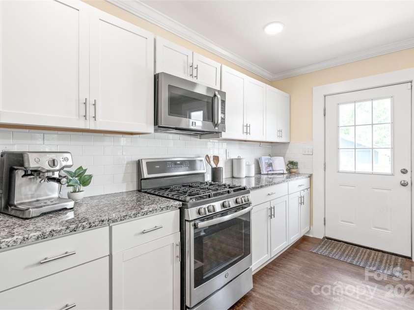 219 Lee Street, Fort Mill, SC 29715.  MLS# CAR4257682, YatesRealty ID 16267. Cook like a pro with stainless steel gas stove, microwave, and oven—style meets function in the heart of the home.