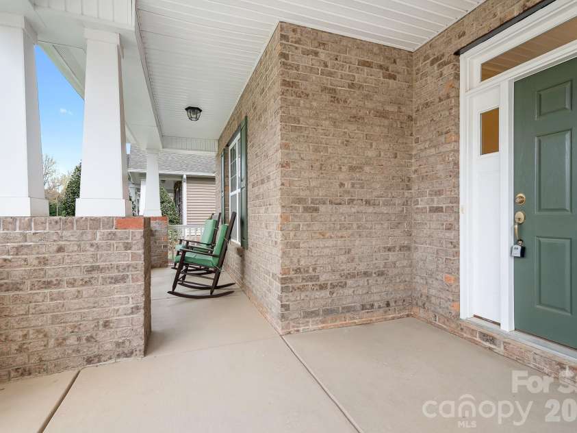 12728 Meetinghouse Drive, Cornelius, NC 28031.  MLS# CAR4361291, YatesRealty ID 16284. Rocking chair front porch