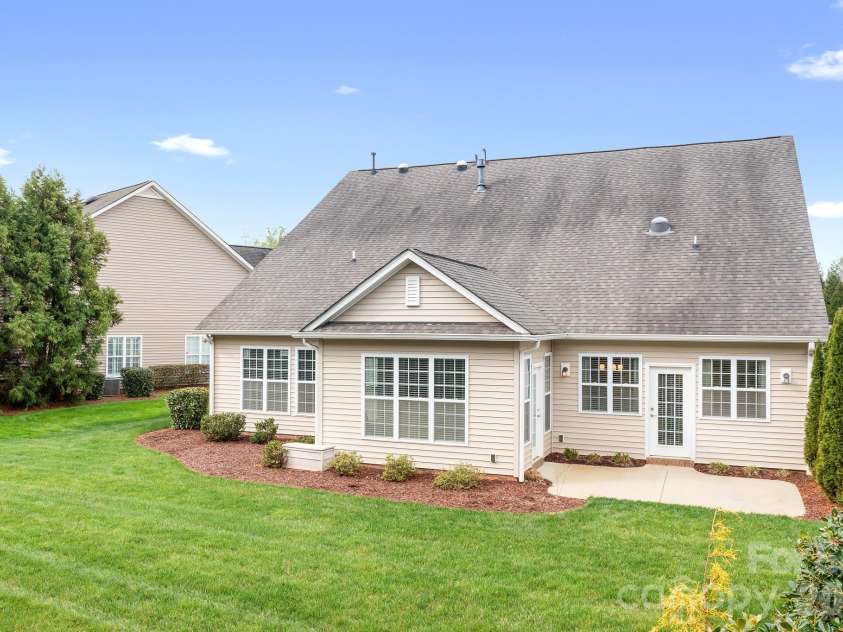 12728 Meetinghouse Drive, Cornelius, NC 28031.  MLS# CAR4361291, YatesRealty ID 16284. Side view with patio