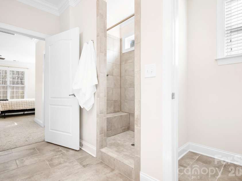 12728 Meetinghouse Drive, Cornelius, NC 28031.  MLS# CAR4361291, YatesRealty ID 16284. Walk in shower with seat and grab bar