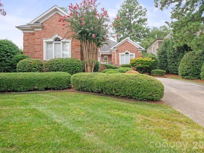 17426 Springwinds Drive, Cornelius, NC 28031.  MLS# CAR4333275, YatesRealty ID 16307. Front of this brick ranch with courtyard style garage