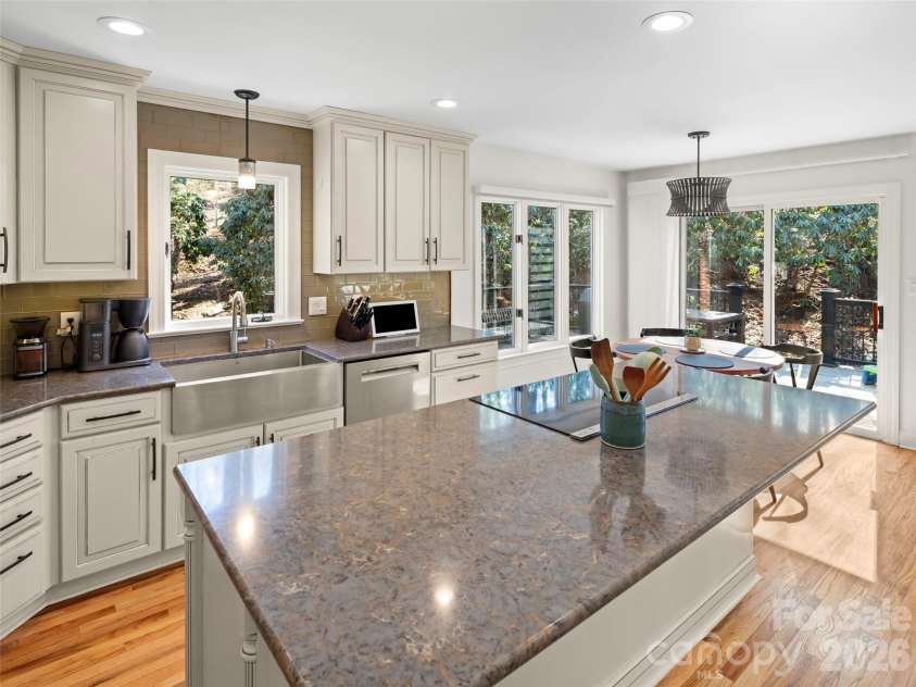 109 Galloway Drive, Asheville, NC 28803.  MLS# CAR4343721, YatesRealty ID 16308. This light-filled kitchen features generous window placement, maximizing natural light while providing inviting views of the outdoors