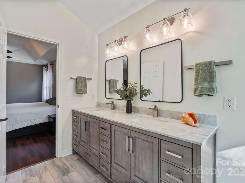 123 Southhaven Drive, Mooresville, NC 28117.  MLS# CAR4322533, YatesRealty ID 16318. Primary bathroom with dual sinks and tile floors