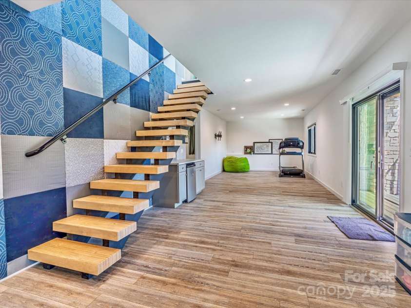 75 Ladyslipper Lane, Waynesville, NC 28786.  MLS# CAR4241976, YatesRealty ID 16337. The fabulous fabric wall extends both floors