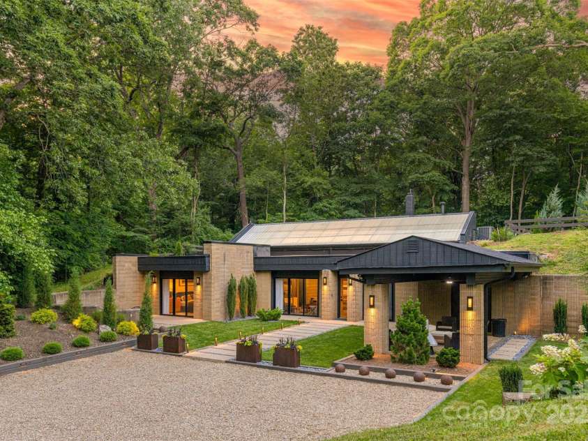 46 Dortch Avenue, Asheville, NC 28801.  MLS# CAR4146963, YatesRealty ID 16353. Rewind time in this Iconic Eco-Architectural Gem known as The Remington. Designed by local architect Richard A. Webster and commissioned by Dr. & Mrs. Lloyd Remington in the 1970s, this earth shelter emerges from a hillsi