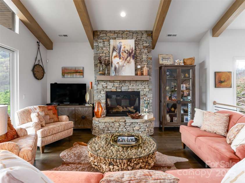 9 Freshwater Cove, Maggie Valley, NC 28751.  MLS# CAR4248670, YatesRealty ID 16357. Gas fireplace with stone surround