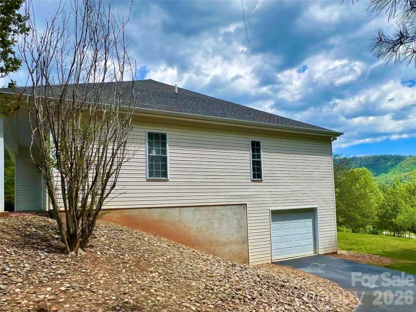 7 Curtis Drive, Hendersonville, NC 28739.  MLS# CAR4372941, YatesRealty ID 16361. One Car Garage on Basement Level