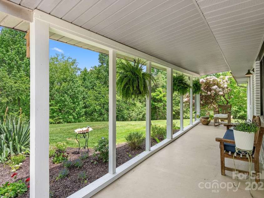 9 Mikayla Lane, Candler, NC 28715.  MLS# CAR4242075, YatesRealty ID 16364. Covered rocking chair front porch with views of your own pasture and forest