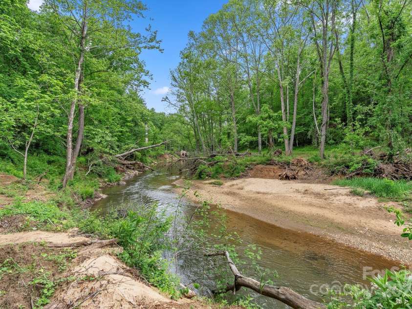 9 Mikayla Lane, Candler, NC 28715.  MLS# CAR4242075, YatesRealty ID 16364. Hominy Creek breached her banks during Helene and left sand