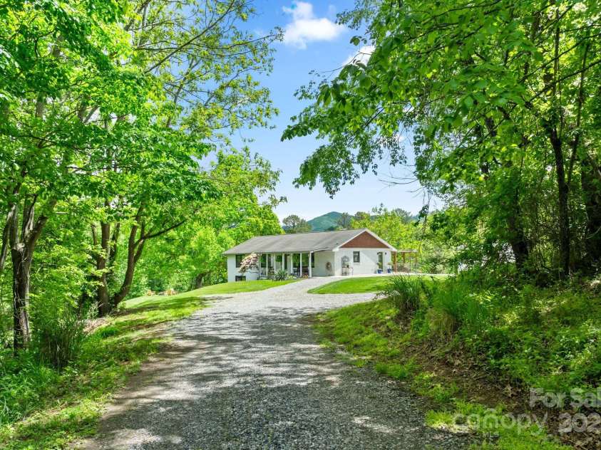 9 Mikayla Lane, Candler, NC 28715.  MLS# CAR4242075, YatesRealty ID 16364. Long, flat driveway with fresh gravel welcomes you home