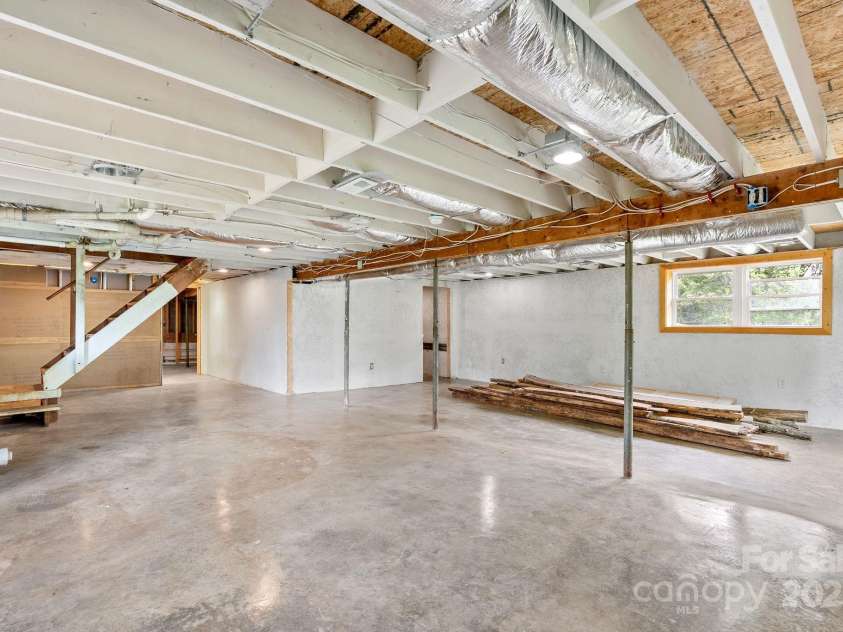 9 Mikayla Lane, Candler, NC 28715.  MLS# CAR4242075, YatesRealty ID 16364. Polished concrete, studded walls and electrical ready to expand your square footage