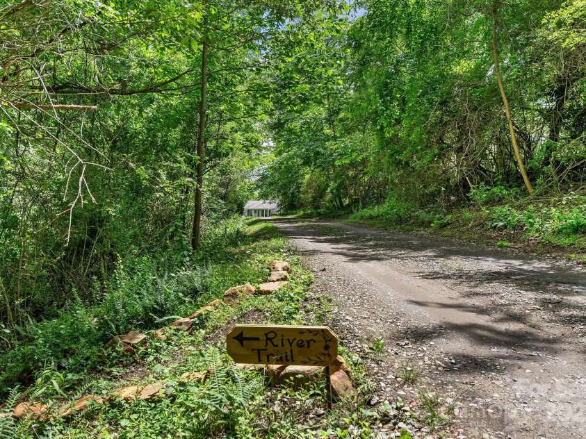 9 Mikayla Lane, Candler, NC 28715.  MLS# CAR4242075, YatesRealty ID 16364. Private trail through forest to Hominy Creek