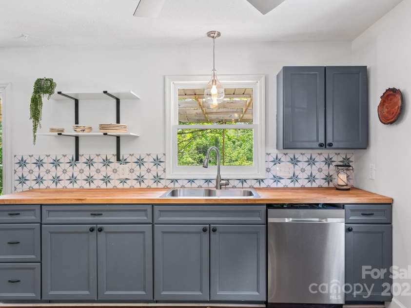 9 Mikayla Lane, Candler, NC 28715.  MLS# CAR4242075, YatesRealty ID 16364. Sweet cutting board counter top with open shelving and darling backsplash