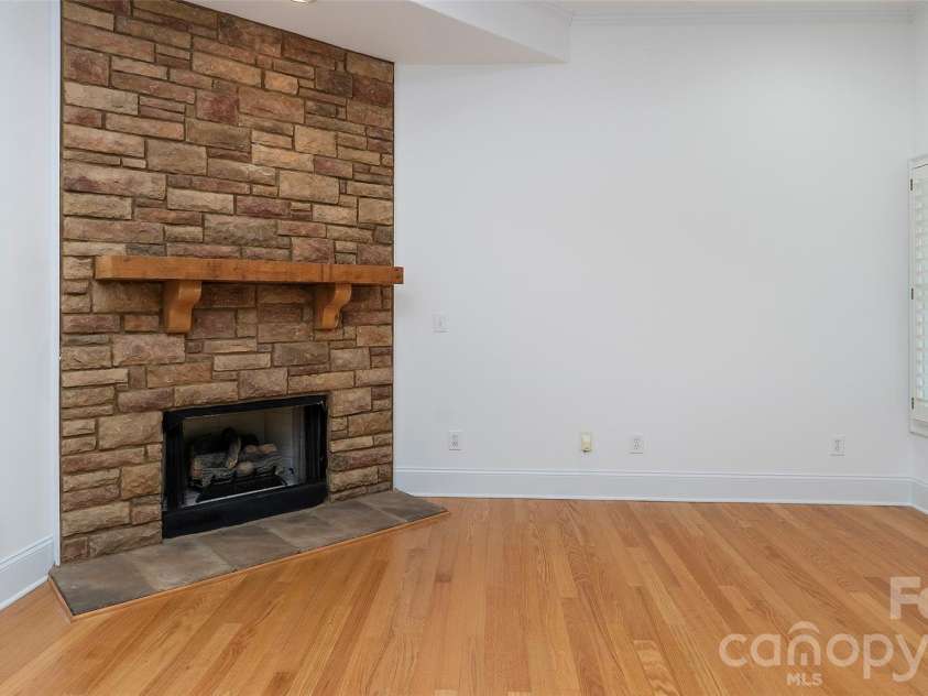 4709 Trey View Court, Mint Hill, NC 28227.  MLS# CAR4173427, YatesRealty ID 16368. Close up of stone to ceiling fp-ventless gas logs, natural wood mantel