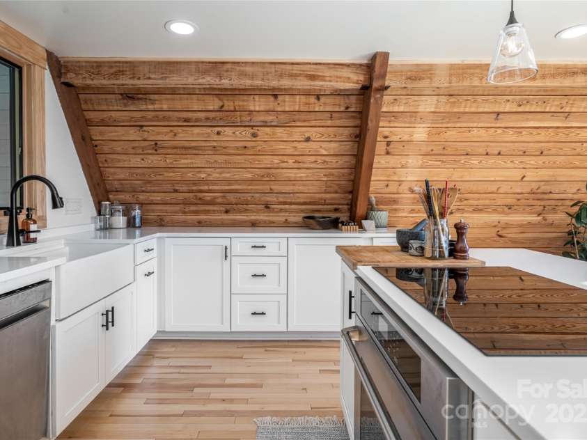 360 Banjo Branch Road, Burnsville, NC 28714.  MLS# CAR4310323, YatesRealty ID 1637. The home features an induction stovetop and ample storage. 