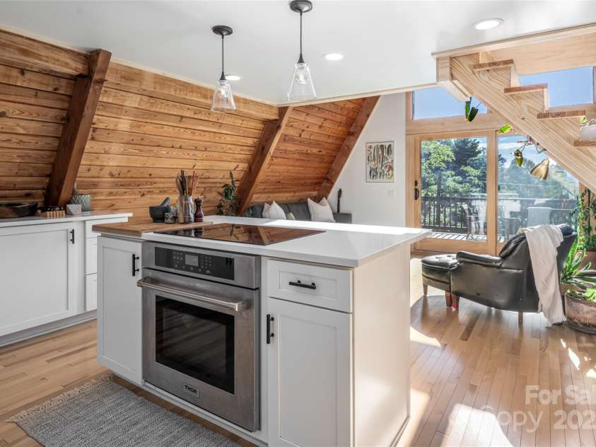 360 Banjo Branch Road, Burnsville, NC 28714.  MLS# CAR4310323, YatesRealty ID 1637. The home features an open floor plan with floor to ceiling windows with mountain views. 