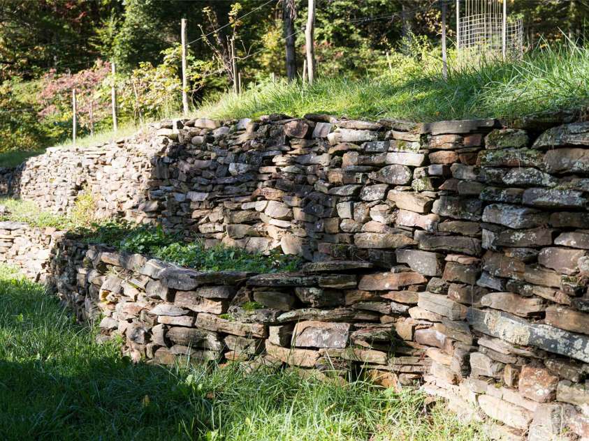 360 Banjo Branch Road, Burnsville, NC 28714.  MLS# CAR4310323, YatesRealty ID 1637. The property features many stone walls and is terraced for garden use. 