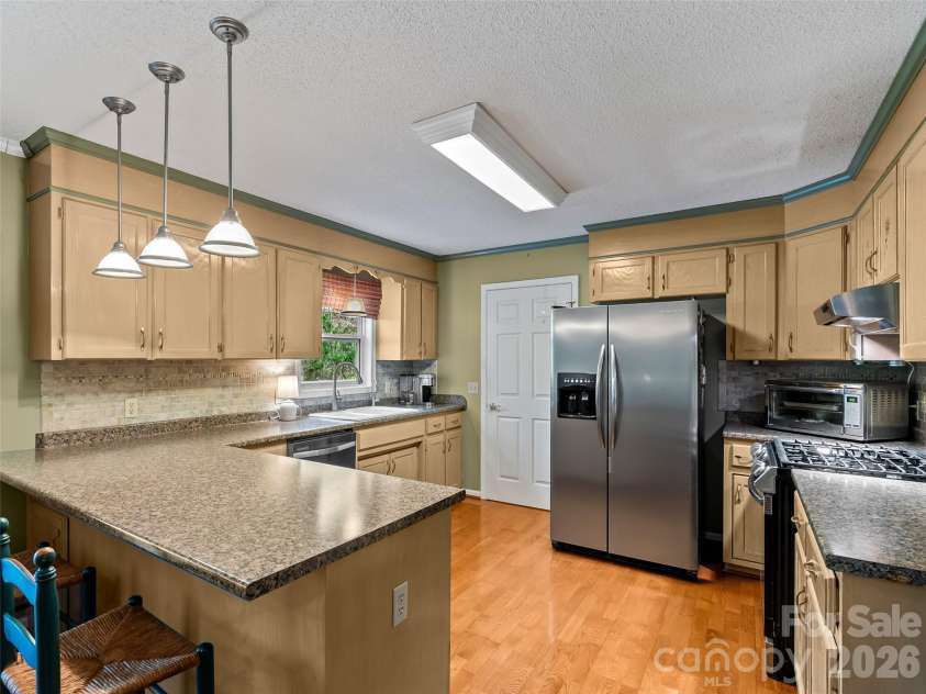 36 Justin Drive, Etowah, NC 28729.  MLS# CAR4373480, YatesRealty ID 16371. Kitchen with bar top seating
