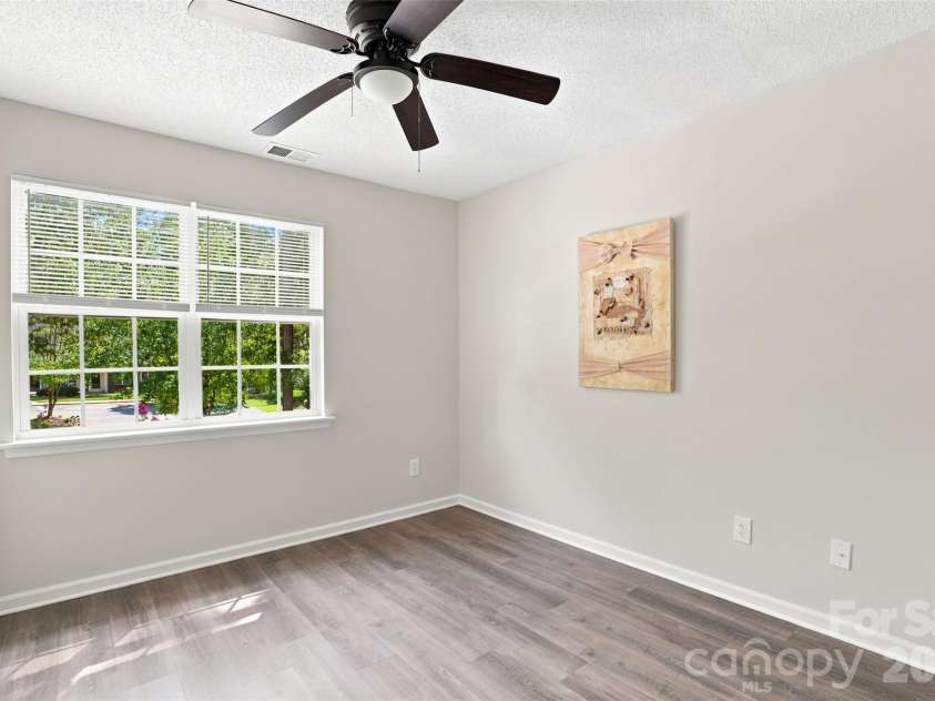6766 Cypress Tree Lane, Charlotte, NC 28215.  MLS# CAR4415142, YatesRealty ID 16391. Bright upper-level secondary bedroom with updated flooring and new ceiling fan