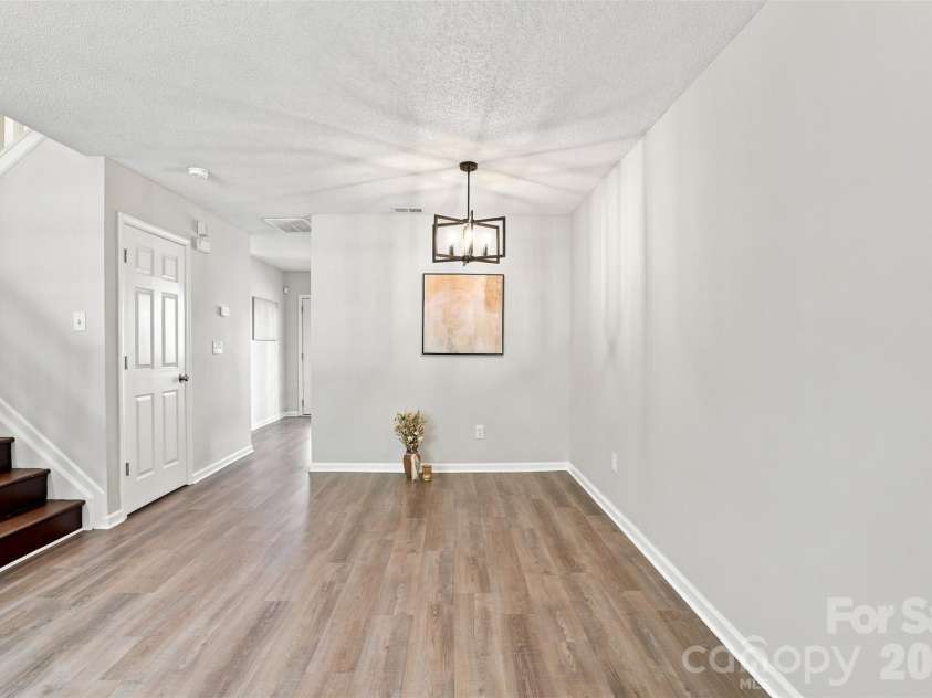 6766 Cypress Tree Lane, Charlotte, NC 28215.  MLS# CAR4415142, YatesRealty ID 16391. Defined dining area with a stylish updated light fixture and ample space for gathering