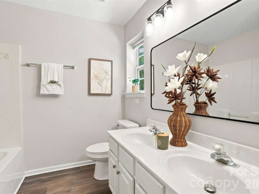 6766 Cypress Tree Lane, Charlotte, NC 28215.  MLS# CAR4415142, YatesRealty ID 16391. Private en-suite bath featuring a double-sink vanity and oversized mirror