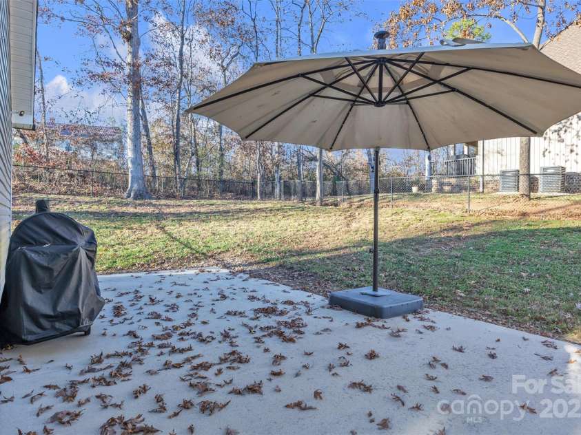 312 Oak Knoll, Hildebran, NC 28637.  MLS# CAR4325397, YatesRealty ID 16393. Back patio area looking into fenced back yard