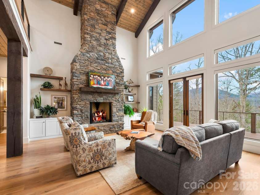 567 Wild River Run, Marshall, NC 28753.  MLS# CAR4353270, YatesRealty ID 16403. Great room with soaring ceilings and stacked stone fireplace.