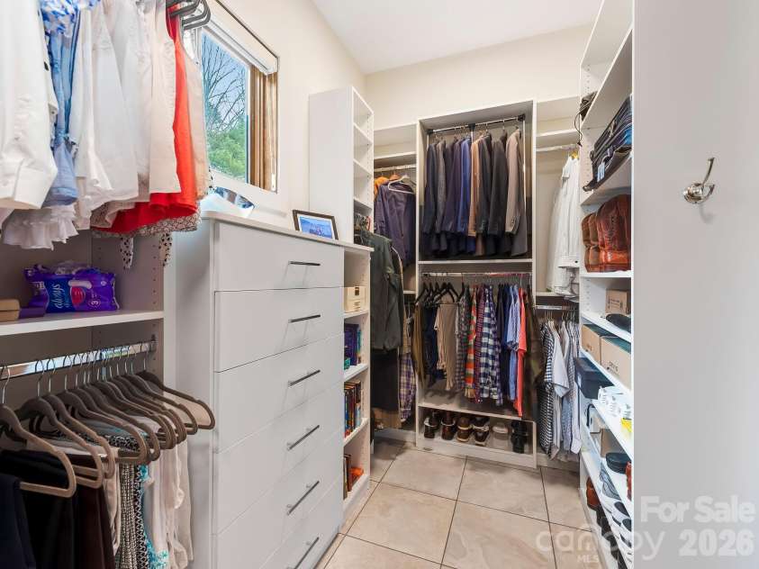 567 Wild River Run, Marshall, NC 28753.  MLS# CAR4353270, YatesRealty ID 16403. Primary closet with built-ins and a light sensor door.