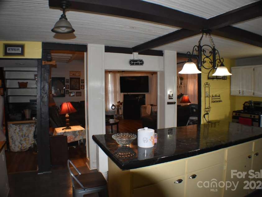 306 McAdenville Road, Lowell, NC 28098.  MLS# CAR4204195, YatesRealty ID 16406. Extra Large Kitchen Island Looking Back Into Living Room