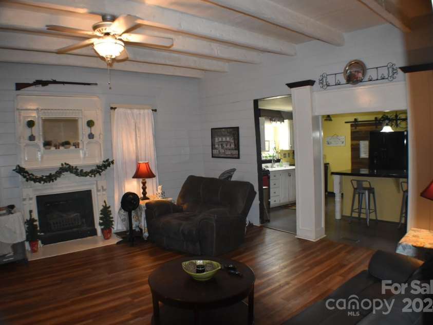306 McAdenville Road, Lowell, NC 28098.  MLS# CAR4204195, YatesRealty ID 16406. Living Roomwith High Ceilings and Exposed Beams