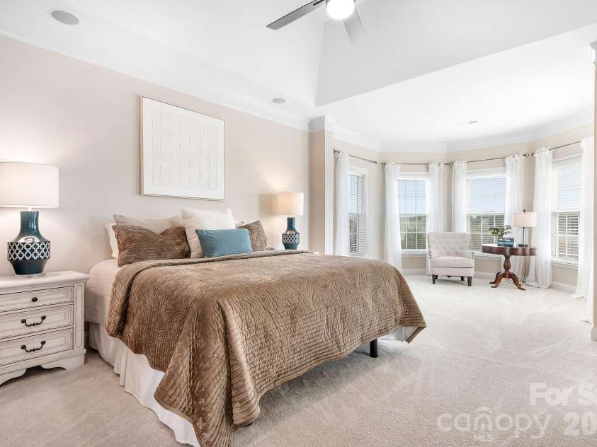 1546 Valhalla Drive, Denver, NC 28037.  MLS# CAR4353456, YatesRealty ID 16408. The primary suite is just that...sweet! Enter into a spacious suite with a charming sitting area overlooking the golf course.  Elevated ceiling adds to the elegance of this personal space.