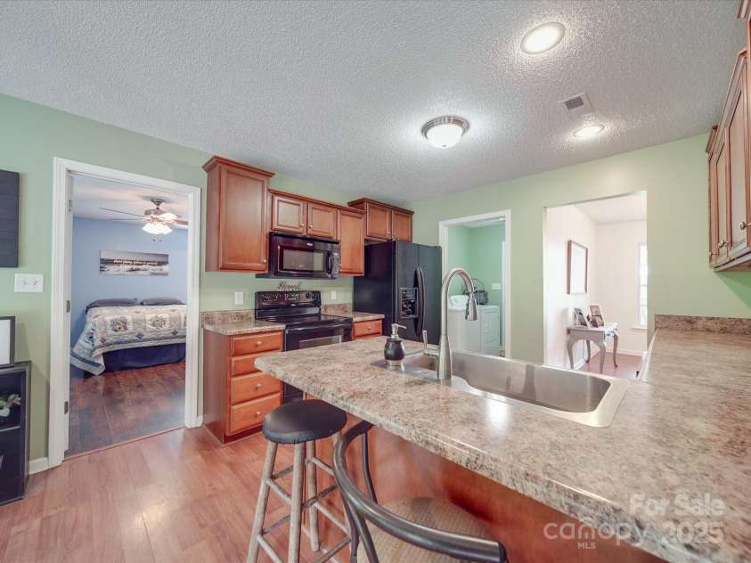 1060 Lentz Harness Shop Road, Mount Pleasant, NC 28124.  MLS# CAR4265582, YatesRealty ID 16422. Kitchen with Breakfast Bar