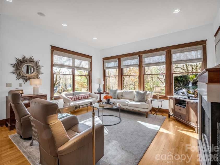720 Overlook Drive, Flat Rock, NC 28731.  MLS# CAR4365121, YatesRealty ID 16429. Light-filled living room with expansive corner window