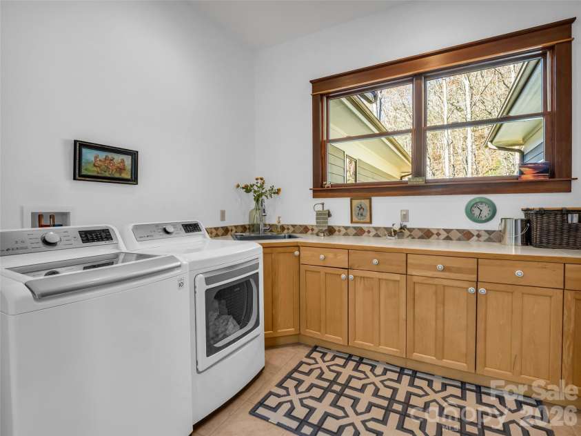 720 Overlook Drive, Flat Rock, NC 28731.  MLS# CAR4365121, YatesRealty ID 16429. Spacious laundry with storage and workspac