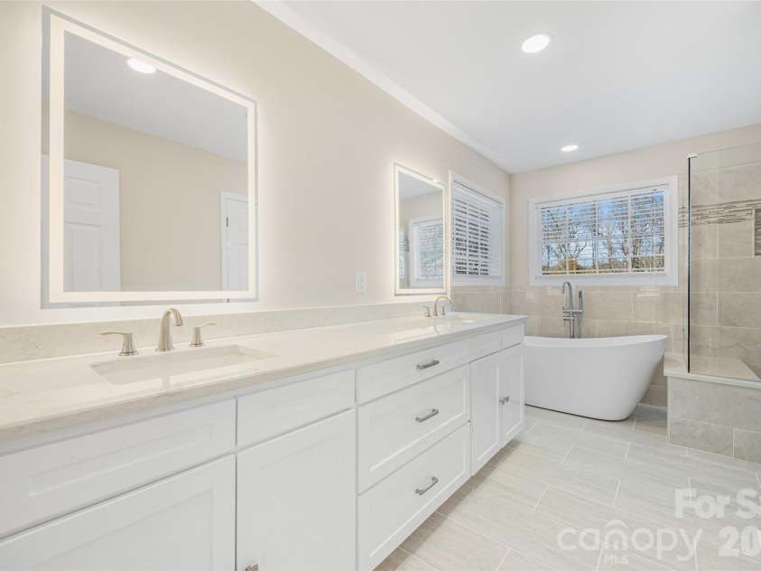 2912 Tallard Lane, Charlotte, NC 28270.  MLS# CAR4336197, YatesRealty ID 16432. Primary Bath with Spa Features Including Smart LED Mirrors and Custom Vanity