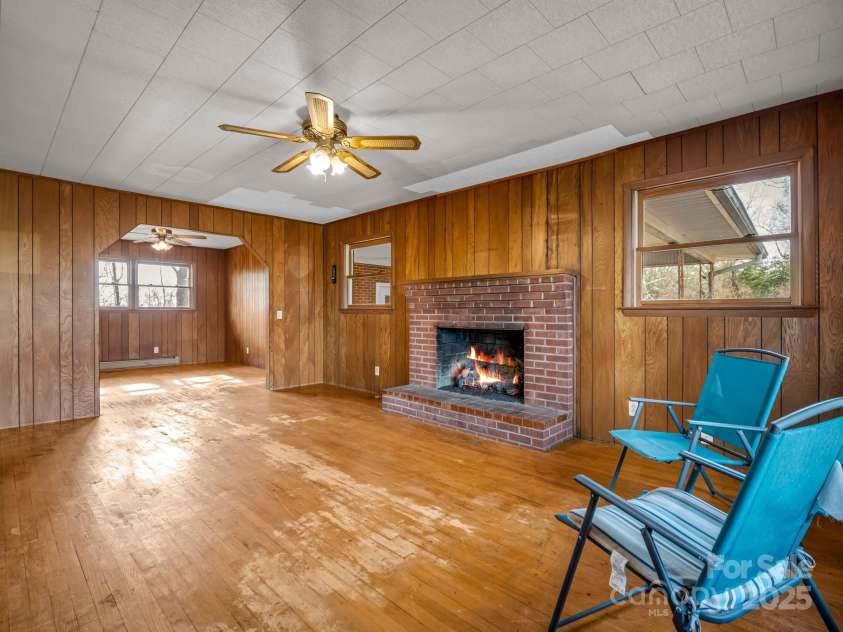 6 Rachel Bell Road, Mill Spring, NC 28756.  MLS# CAR4311830, YatesRealty ID 16446. Living room w/gas logs