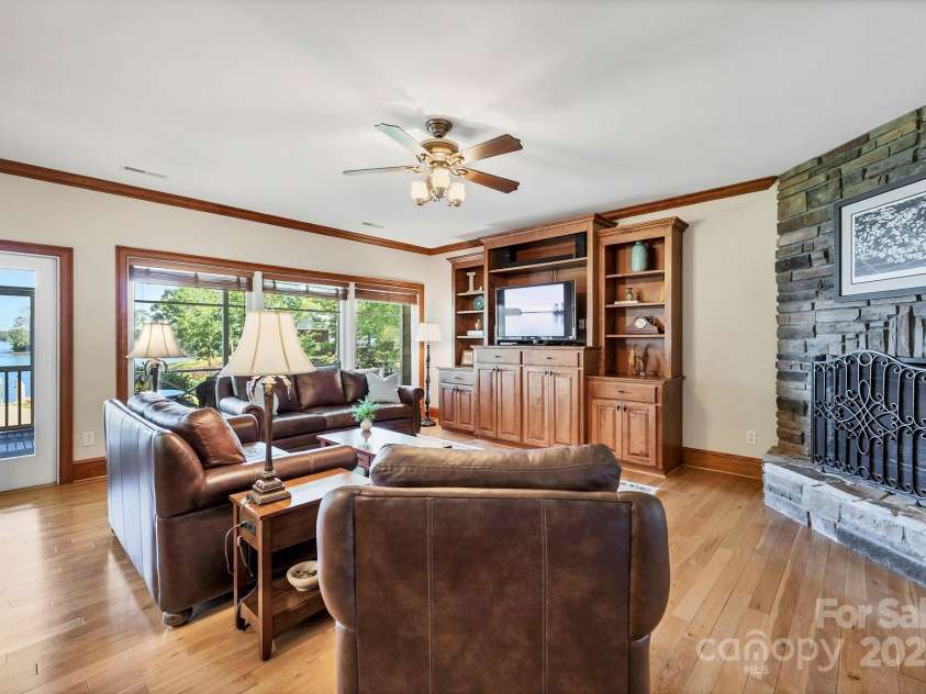 2102 Lake Road, Ridgeway, SC 29130.  MLS# CAR4256737, YatesRealty ID 16450. Den features built-ins for storage, open to Kitchen and access to screened porch.