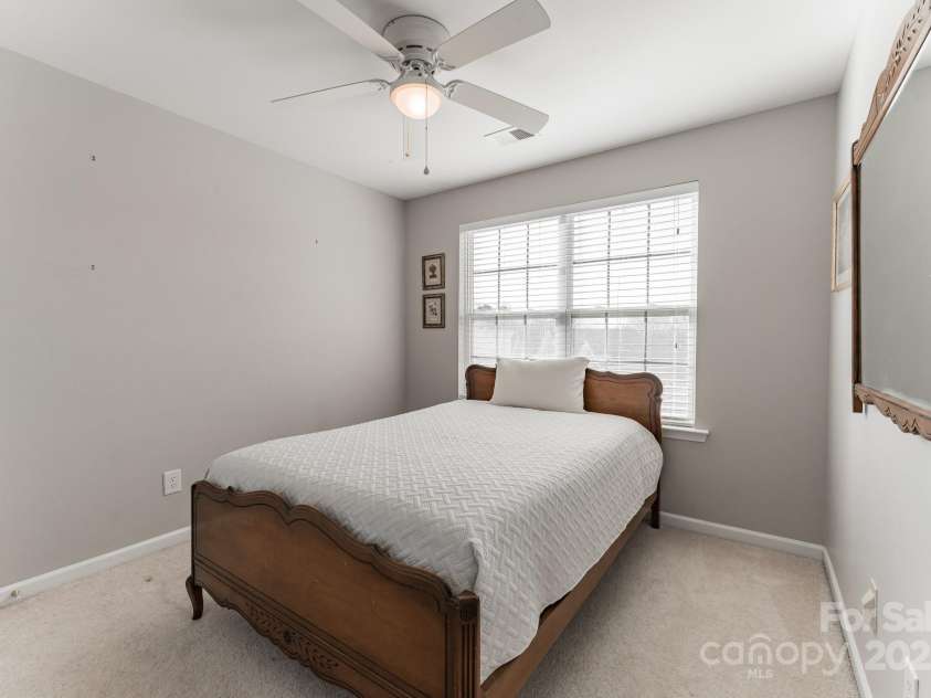 8009 Whitehawk Hill Road, Waxhaw, NC 28173.  MLS# CAR4232872, YatesRealty ID 16475. Bright and airy bedroom with a large window, offering plenty of natural light.