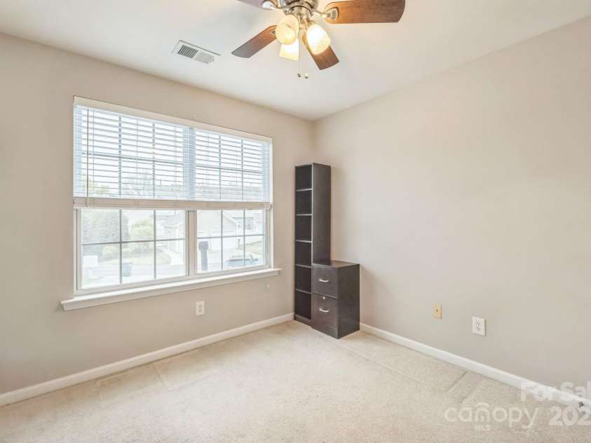8009 Whitehawk Hill Road, Waxhaw, NC 28173.  MLS# CAR4232872, YatesRealty ID 16475. Bright third bedroom with a large window, perfect for relaxing or as a home office.